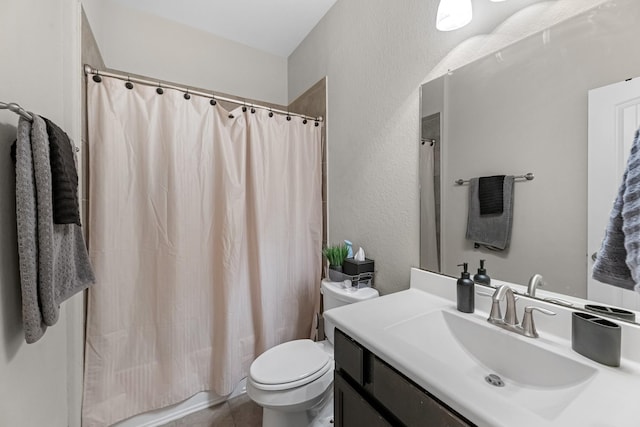bathroom with a textured wall, shower / bath combo with shower curtain, toilet, vanity, and tile patterned flooring
