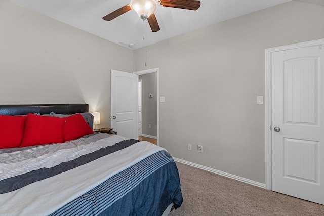 carpeted bedroom featuring ceiling fan and baseboards