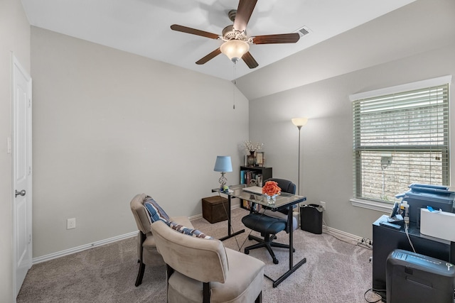 office space with ceiling fan, vaulted ceiling, light colored carpet, and baseboards