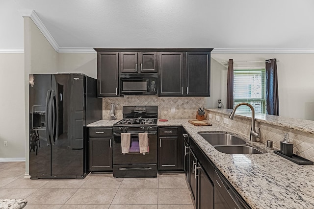 kitchen featuring black appliances, decorative backsplash, crown molding, and a sink