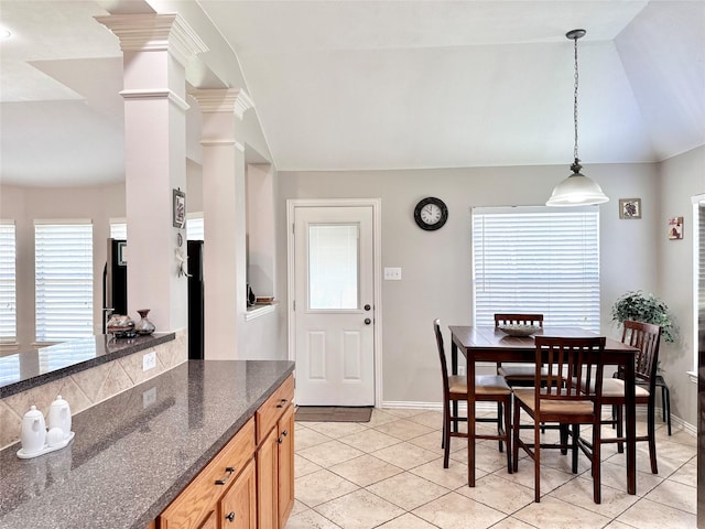 16038 Belleshire Ln, Houston, TX 77084 - dining room with vaulted ceiling, light tile patterned floors, baseboards, and ornate columns
