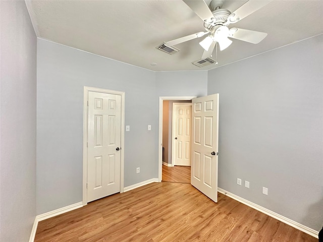 16038 Belleshire Ln, Houston, TX 77084 - unfurnished bedroom with light wood-type flooring, baseboards, and ceiling fan
