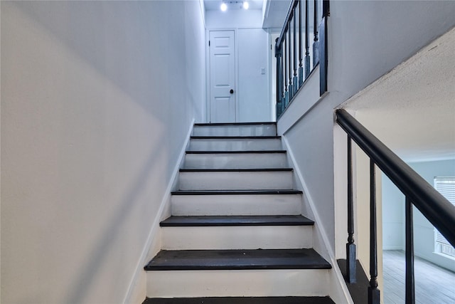 2574 Marilee Ln Unit 1, Houston, TX 77057 - stairs with baseboards and wood finished floors