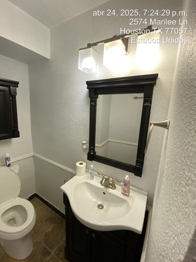 2574 Marilee Ln Unit 1, Houston, TX 77057 - bathroom with toilet, baseboards, and vanity