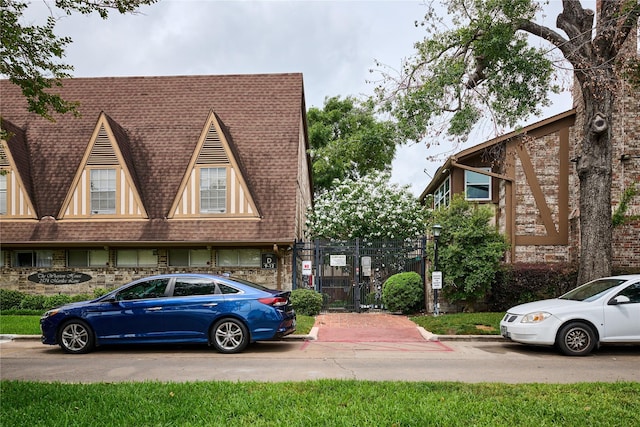 2574 Marilee Ln Unit 1, Houston, TX 77057 - view of front facade featuring fence, a shingled roof, and a gate