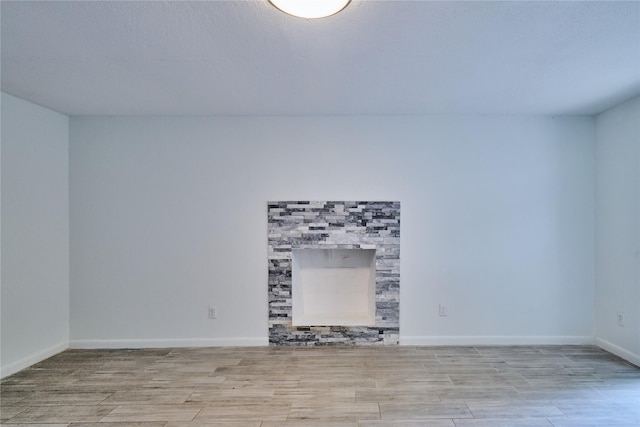 2574 Marilee Ln Unit 1, Houston, TX 77057 - unfurnished living room featuring baseboards and wood finished floors