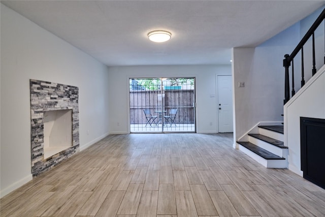2574 Marilee Ln Unit 1, Houston, TX 77057 - unfurnished living room with baseboards, stairs, and light wood-style flooring