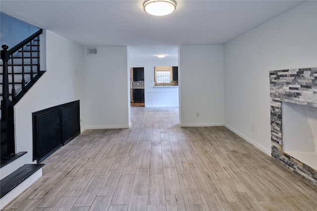 2574 Marilee Ln Unit 1, Houston, TX 77057 - unfurnished living room with stairway, baseboards, wood finished floors, and visible vents