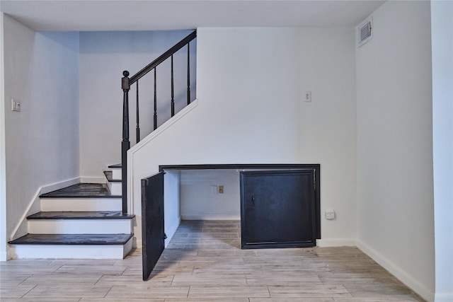 2574 Marilee Ln Unit 1, Houston, TX 77057 - staircase featuring visible vents, baseboards, and wood finished floors