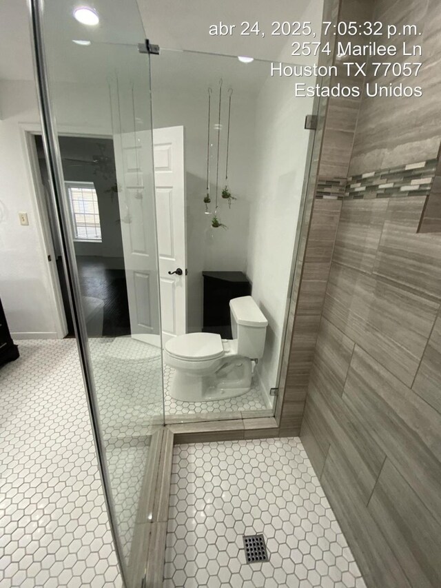 2574 Marilee Ln Unit 1, Houston, TX 77057 - bathroom featuring tile patterned flooring, a tile shower, and toilet