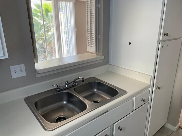 2333 Bering Dr Unit 201, Houston, TX 77057 - details with white cabinetry, light countertops, and a sink