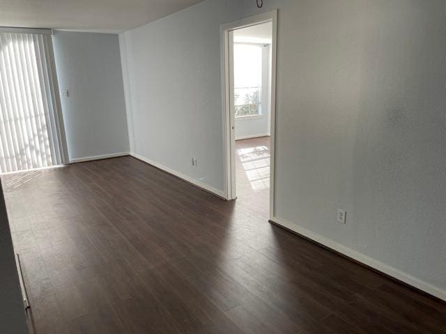 2333 Bering Dr Unit 201, Houston, TX 77057 - empty room featuring dark wood-style flooring and baseboards