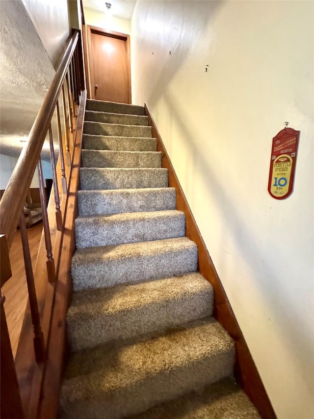 staircase featuring wood finished floors