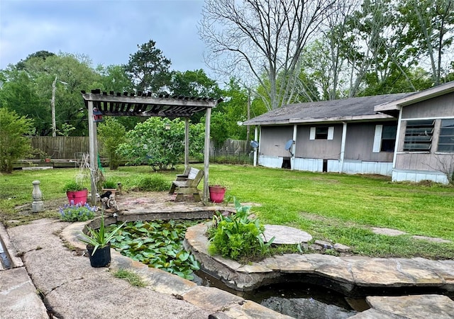 view of yard featuring fence and a pergola