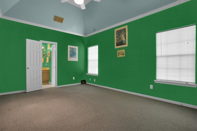 carpeted spare room featuring crown molding, baseboards, and visible vents
