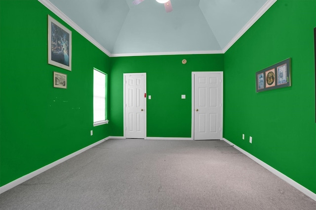 spare room featuring crown molding, baseboards, and carpet floors