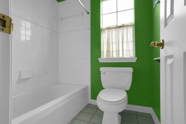 bathroom with toilet, baseboards, shower / bath combination, and tile patterned flooring