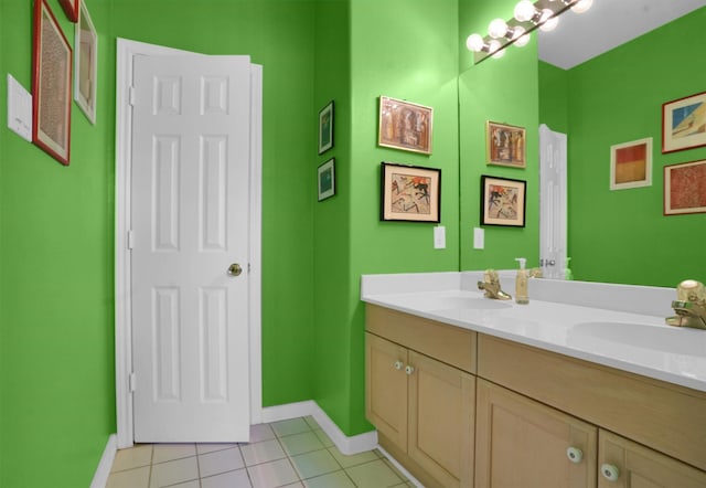 bathroom featuring a sink, baseboards, and tile patterned floors