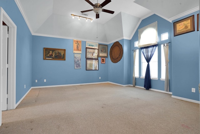 unfurnished room featuring baseboards, carpet, ceiling fan, and vaulted ceiling