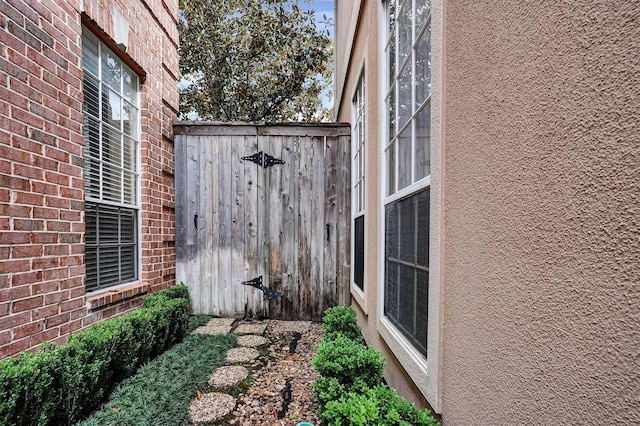 view of side of home with brick siding