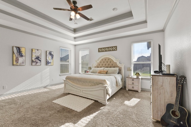 bedroom featuring a raised ceiling, a ceiling fan, carpet, baseboards, and ornamental molding