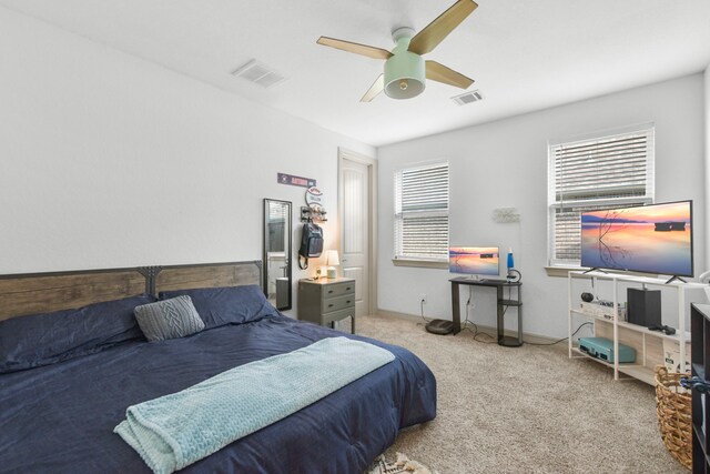 bedroom featuring visible vents, a ceiling fan, and carpet floors