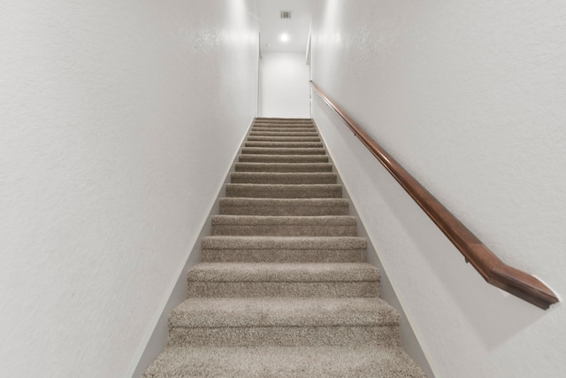 stairway with a textured wall