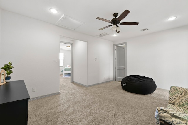 sitting room with attic access, carpet flooring, ceiling fan, and baseboards