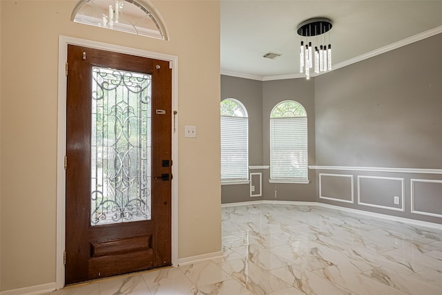 11911 Timpnogos Dr, Tomball, TX 77377 - entrance foyer with crown molding, marble finish floor, visible vents, baseboards, and wainscoting