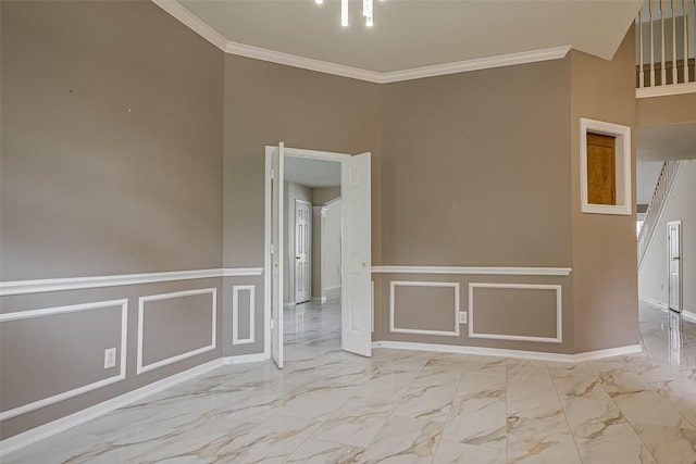 11911 Timpnogos Dr, Tomball, TX 77377 - unfurnished room featuring crown molding, a wainscoted wall, marble finish floor, and a decorative wall