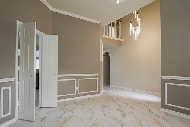 11911 Timpnogos Dr, Tomball, TX 77377 - interior space with a notable chandelier, crown molding, marble finish floor, a towering ceiling, and arched walkways