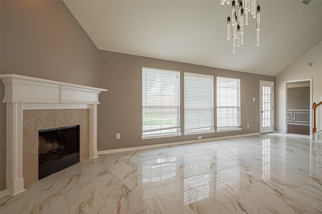 11911 Timpnogos Dr, Tomball, TX 77377 - unfurnished living room with vaulted ceiling, a wealth of natural light, a tile fireplace, and marble finish floor