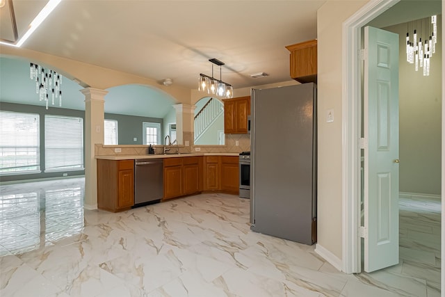 11911 Timpnogos Dr, Tomball, TX 77377 - kitchen featuring a sink, stainless steel appliances, decorative columns, brown cabinetry, and marble finish floor
