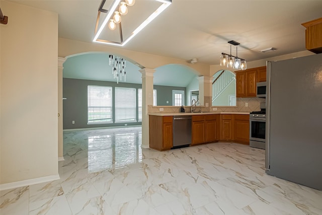 11911 Timpnogos Dr, Tomball, TX 77377 - kitchen featuring stainless steel appliances, decorative columns, brown cabinetry, visible vents, and arched walkways