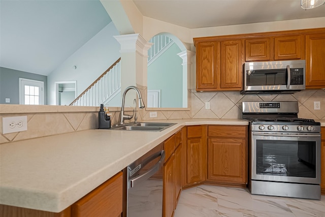 11911 Timpnogos Dr, Tomball, TX 77377 - kitchen with a sink, stainless steel appliances, decorative columns, vaulted ceiling, and light countertops