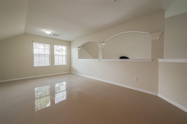 11911 Timpnogos Dr, Tomball, TX 77377 - tiled empty room featuring baseboards, visible vents, decorative columns, and vaulted ceiling