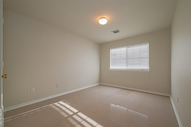 11911 Timpnogos Dr, Tomball, TX 77377 - empty room with baseboards, visible vents, and light tile patterned flooring