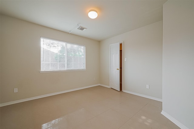 11911 Timpnogos Dr, Tomball, TX 77377 - spare room featuring light tile patterned flooring, visible vents, and baseboards
