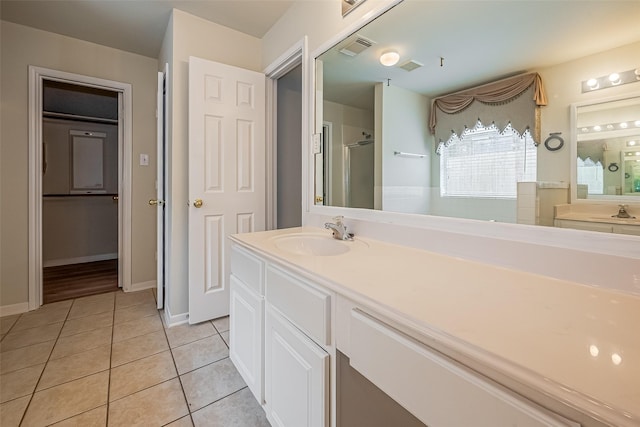 11911 Timpnogos Dr, Tomball, TX 77377 - full bathroom with vanity, visible vents, a shower stall, and tile patterned floors