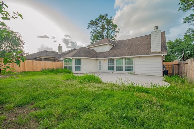 11911 Timpnogos Dr, Tomball, TX 77377 - rear view of property featuring a chimney, a patio area, and a fenced backyard