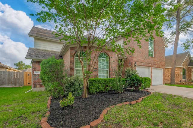 11911 Timpnogos Dr, Tomball, TX 77377 - traditional-style house featuring a front lawn, brick siding, concrete driveway, an attached garage, and fence