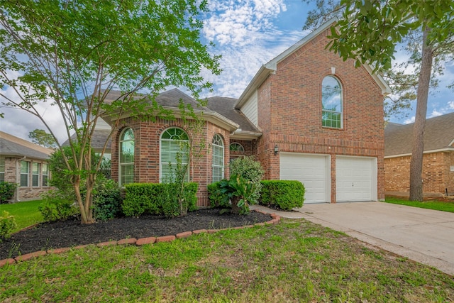 11911 Timpnogos Dr, Tomball, TX 77377 - traditional home featuring a garage, brick siding, concrete driveway, and roof with shingles