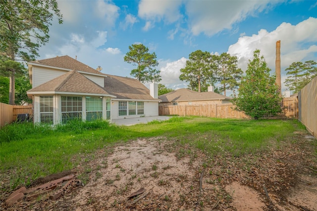 11911 Timpnogos Dr, Tomball, TX 77377 - back of property with a patio area, a sunroom, a shingled roof, and a fenced backyard