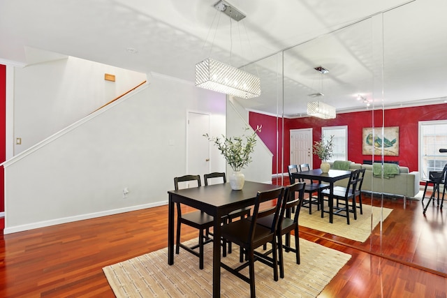 dining space with wood finished floors and baseboards