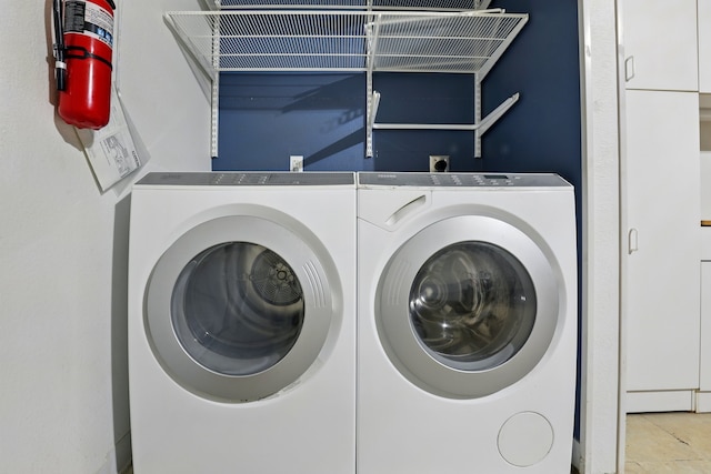 laundry area featuring independent washer and dryer and tile patterned flooring