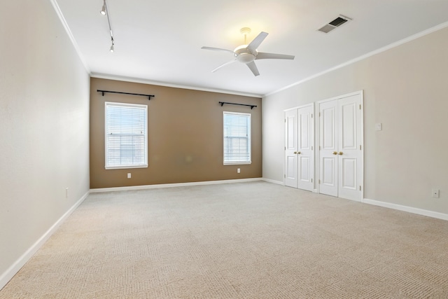 unfurnished bedroom with ornamental molding, two closets, multiple windows, and visible vents