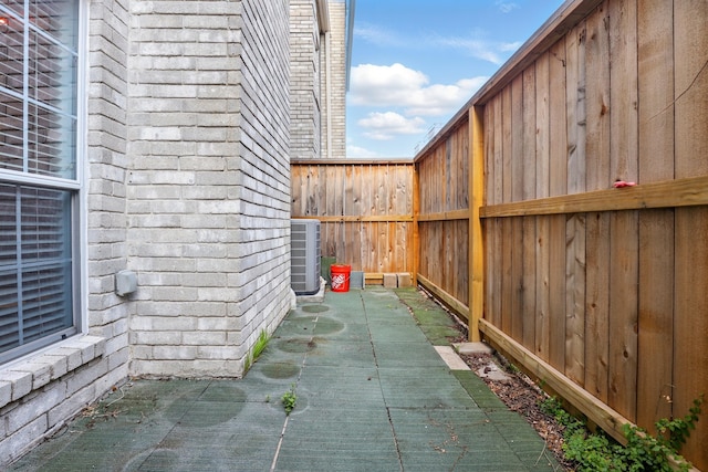 view of patio / terrace featuring fence and central AC unit