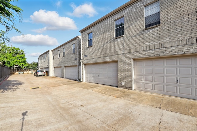 exterior space with fence and brick siding