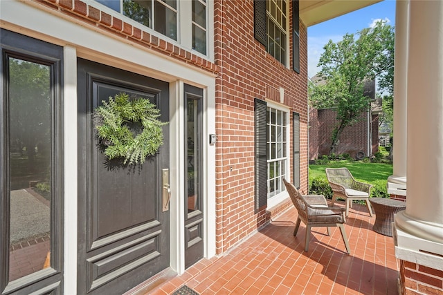 doorway to property featuring brick siding