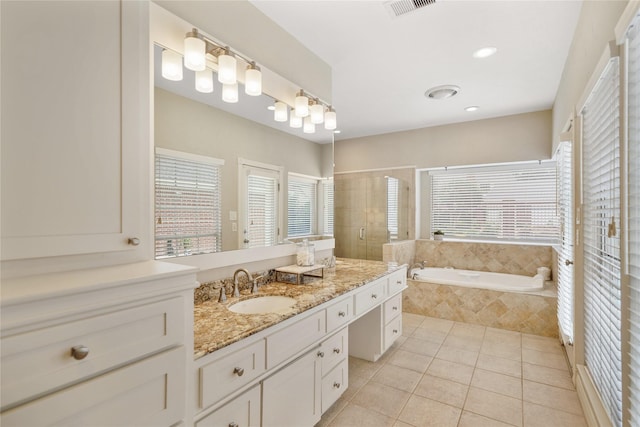 bathroom with tile patterned flooring, plenty of natural light, a stall shower, and a bath